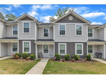 Charming townhome with gray vinyl siding, well-manicured landscaping, and inviting walkway at 918 E Green St # F105, Franklinton, NC 27525