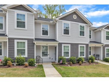 Charming townhome with manicured lawn, covered entry, and American flag for curb appeal at 918 E Green St # F105, Franklinton, NC 27525