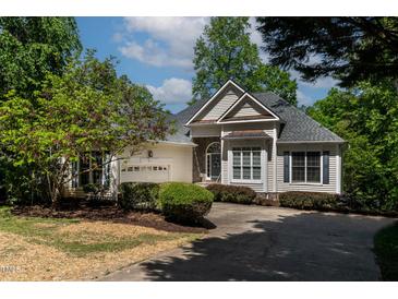 Charming one-story home features a stone accent wall and manicured landscaping at 959 Sagamore Dr, Louisburg, NC 27549