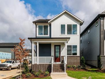 Charming two-story home features a welcoming front porch and appealing modern design at 10 Relaxing Way, Pittsboro, NC 27312