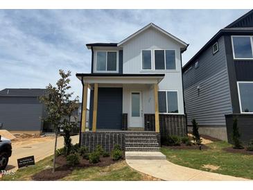 Charming two-story home with brick accents and a welcoming front porch at 10 Relaxing Way, Pittsboro, NC 27312