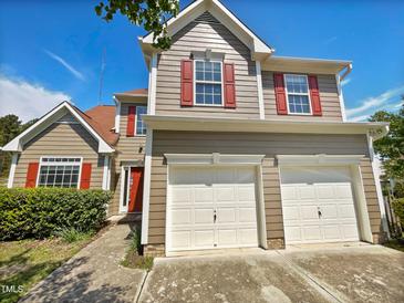 Charming two-story home featuring a two-car garage, red shutters, and a well-maintained front yard at 10 Sandy Bluff Ct, Durham, NC 27703