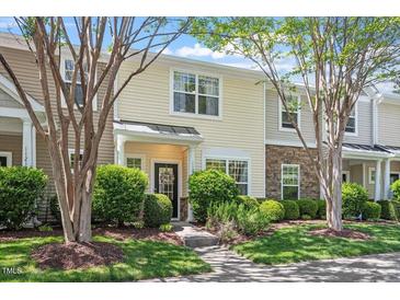 Charming townhome with stone accents and well-maintained landscaping under a blue sky at 11210 Lofty Heights Pl, Raleigh, NC 27614
