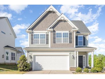 Charming two-story home with a two-car garage and attractive architectural details at 12 Douglas Fir Pl, Clayton, NC 27520