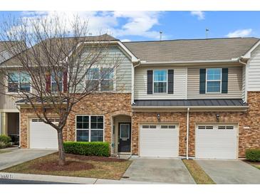 Charming townhome with a stone facade, one-car garage and manicured landscaping at 15 Plumas Drive Dr, Durham, NC 27705