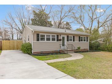 Charming single-story home with a well-maintained front yard, concrete driveway, and welcoming entrance at 2014 Walnut St, Durham, NC 27705