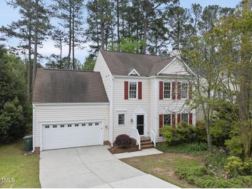 Charming two-story home with red shutters and a well-manicured lawn at 207 Ashley Brook Ct, Cary, NC 27513