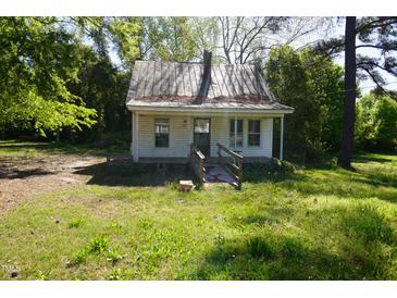 Exterior of home with a small porch, roof and yard with trees at 223 Gum Ave, Spring Hope, NC 27882
