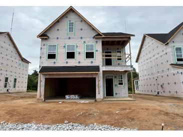 New two-story home featuring a spacious garage and covered porch awaiting finishing touches at 255 Meadowbark Bnd # 31, Garner, NC 27529