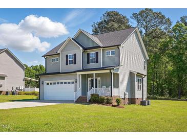 Charming two-story home with a manicured lawn, attached garage, and inviting front porch at 263 Annali Way, Wendell, NC 27591