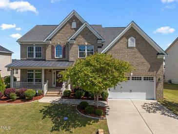 Charming brick two-story home with landscaped front yard and attached two-car garage at 316 Hilliard Forest Dr, Cary, NC 27519