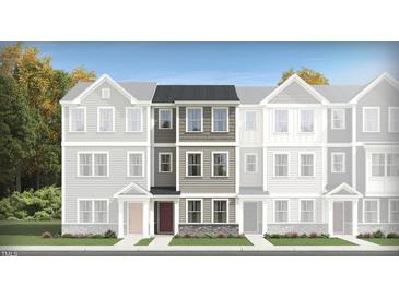 Charming townhouse with gray siding, stone accents, and a welcoming red front door at 336 Carolina Springs Blvd, Apex, NC 27539