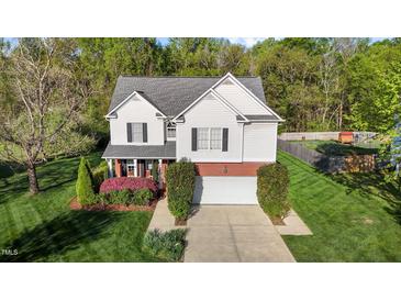 Charming two-story home with a well-manicured lawn and an attached two-car garage, offering curb appeal at 3809 Long Meadow Dr, Mebane, NC 27302
