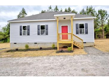 Charming single-story home featuring gray siding, black shutters, and a bright red front door at 58 S Grace Way, Henderson, NC 27537