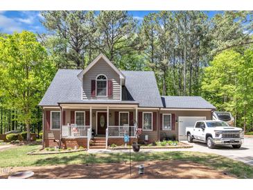 Charming two-story home with a welcoming front porch and well-maintained landscaping at 604 Young Forest Dr, Wake Forest, NC 27587