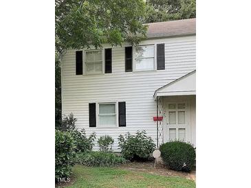 Charming two-story home with white siding, black shutters, and well-maintained landscaping at 1045 Nichols Dr, Raleigh, NC 27605