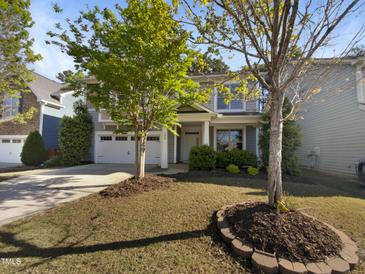 Charming two-story home featuring a well-manicured lawn and a two-car garage at 108 Warm Wood Ln, Apex, NC 27539