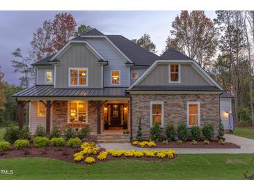 Beautiful stone and shingle home featuring manicured lawn and attractive front porch at , Chapel Hill, NC 27514