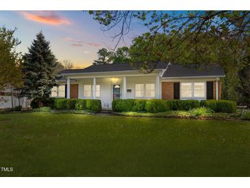 Charming one-story home with manicured front yard and classic white pillars at 410 Long Ave, Roxboro, NC 27573