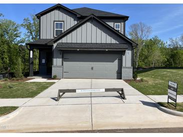 New two-story home with gray siding, a two-car garage and a concrete driveway at 4404 Darius Ct # 41, Fuquay Varina, NC 27526