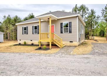Charming single-story home featuring a welcoming front porch and neutral siding with black shutters at 48 S Grace Way, Henderson, NC 27537