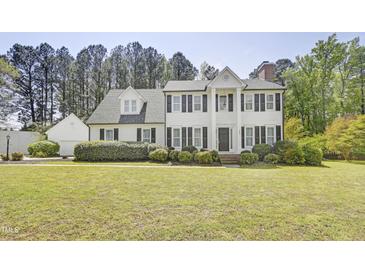 Beautiful two-story home with black shutters, landscaped front yard, and a charming gable-roof garage at 5301 Night Heron Dr, Wake Forest, NC 27587