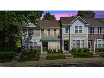 Charming townhome with a well-manicured lawn and inviting curb appeal at 5318 Crescentview Pkwy, Raleigh, NC 27606