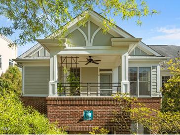Charming exterior view of a two-story home, featuring a covered porch with brick and siding accents at 703 Copperline Dr # 301, Chapel Hill, NC 27516