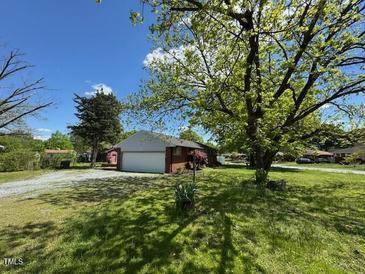 Home exterior with a beautiful yard and a convenient two-car garage at 706 Orchard Dr, Graham, NC 27253