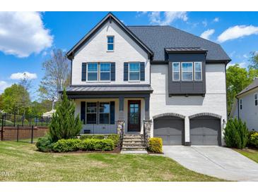 Beautiful two-story home with a two-car garage, stone accents, and a professionally landscaped front yard at 7510 Latteri Ct, Raleigh, NC 27613