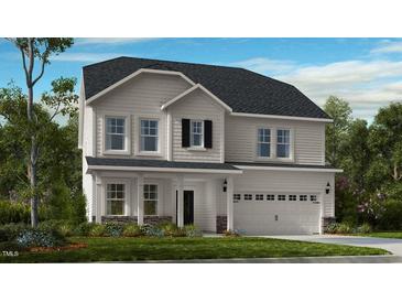Charming two-story home featuring a covered front porch, well-maintained lawn, and classic architectural details at 104 Sodalite Ln, Holly Springs, NC 27540
