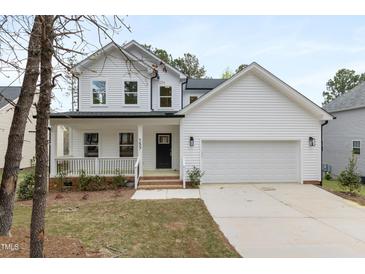 Charming two-story home with a welcoming front porch and attached two-car garage at 157 Maplewood Dr, Sanford, NC 27332