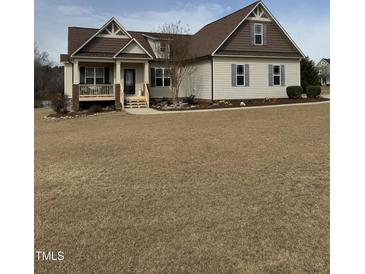 Charming two-story home featuring a covered front porch and a well-maintained yard at 194 Wood Valley Dr, Four Oaks, NC 27524