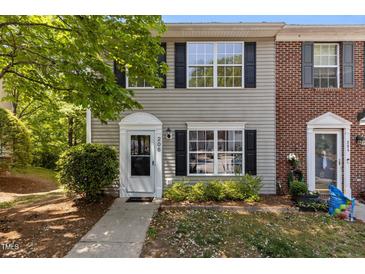 Charming two-story home with vinyl siding, black shutters, and a well-maintained front yard at 206 Black Bird Ct, Cary, NC 27511