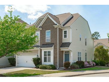 Inviting two-story home featuring brick and siding accents, a well-manicured lawn, and a charming front yard at 2227 Rocky Bay Ct, Cary, NC 27519
