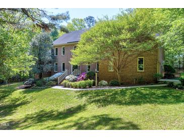 Beautiful two-story brick home with mature landscaping and inviting backyard at 2901 Hunters Bluff Dr, Raleigh, NC 27606