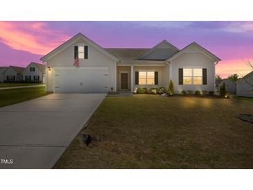 Charming single-Gathering home featuring a well-manicured lawn and attached two-car garage at 367 Fenella Dr, Four Oaks, NC 27524