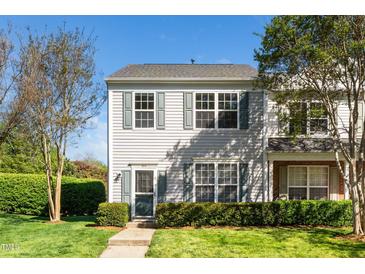 Inviting two-story townhome with green shutters and landscaped front yard, perfect for low-maintenance living at 614 Canyon Lake Cir, Morrisville, NC 27560