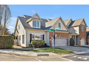 Charming home with a two-car garage, well-maintained lawn, and beautiful landscaping at 103 Aisling Ct, Cary, NC 27513