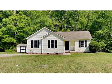 Charming single-story home with neutral siding, black shutters and a well-manicured lawn at 109 Stone Ridge Dr, Smithfield, NC 27577