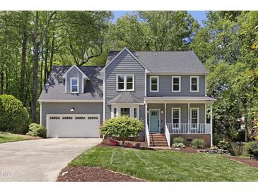 Charming two-story home featuring a well-manicured lawn, inviting front porch and a two-car garage at 110 Chapelwood Way, Cary, NC 27518