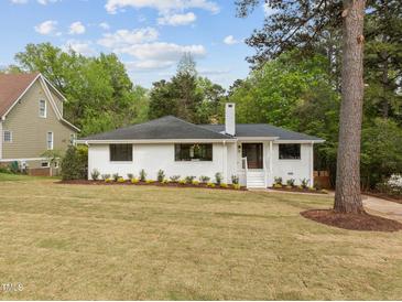 Charming, renovated brick ranch home featuring a beautifully landscaped front yard and inviting entryway at 1310 Mayfair Rd, Raleigh, NC 27608
