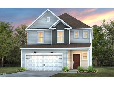 Charming two-story home featuring a two-car garage, light gray siding, and a welcoming front entrance at 1311 Hollyview Ave, Durham, NC 27703