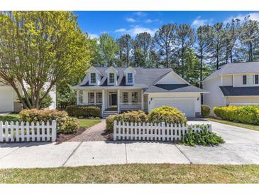 Charming two-story home boasts a manicured lawn and inviting front porch at 1420 Willowleaf Way, Apex, NC 27502