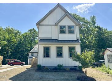Charming two-story home features a modern design and inviting curb appeal at 1448A Maplewood Dr, Durham, NC 27704