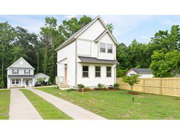 Charming two-story home with a well-maintained lawn and a concrete driveway at 1448A Maplewood Dr, Durham, NC 27704