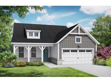 Charming single-Gathering home showcasing a welcoming front porch, two-car garage, and beautifully landscaped yard at 152 Cultivator Ct, Angier, NC 27501