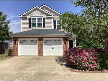 Charming two-story home with a brick facade, two-car garage, and landscaped front yard at 2428 Diquedo Dr, Raleigh, NC 27604