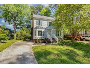 Charming two-story home with a bay window and a well-manicured lawn at 3109 E Folkestone Pl, Raleigh, NC 27604