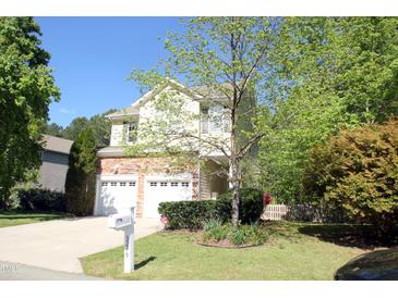 Charming two-story home featuring a stone veneer, attached two-car garage, and well-manicured lawn at 3219 Ranbir Dr, Durham, NC 27713